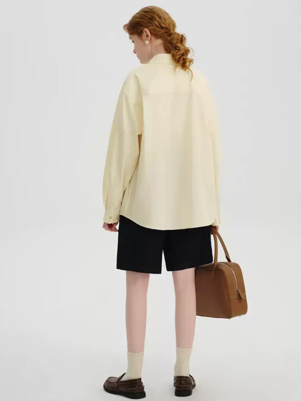 A woman in a cream-colored shirt