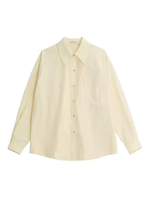 A woman in a cream-colored shirt