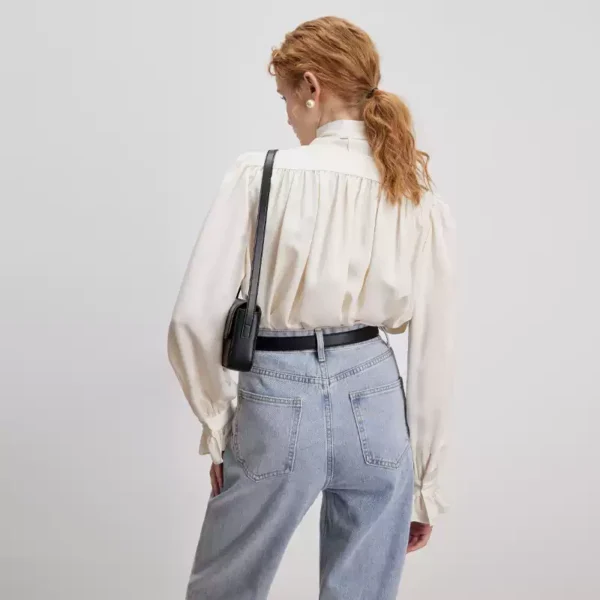 A woman in a bow shirt