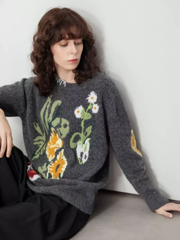 A woman in a color-blocking floral jacquard sweater