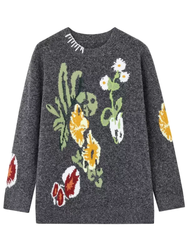 A woman in a color-blocking floral jacquard sweater