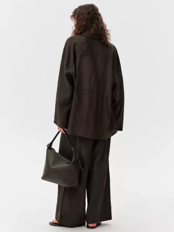 A light shirt and loose trousers suit
