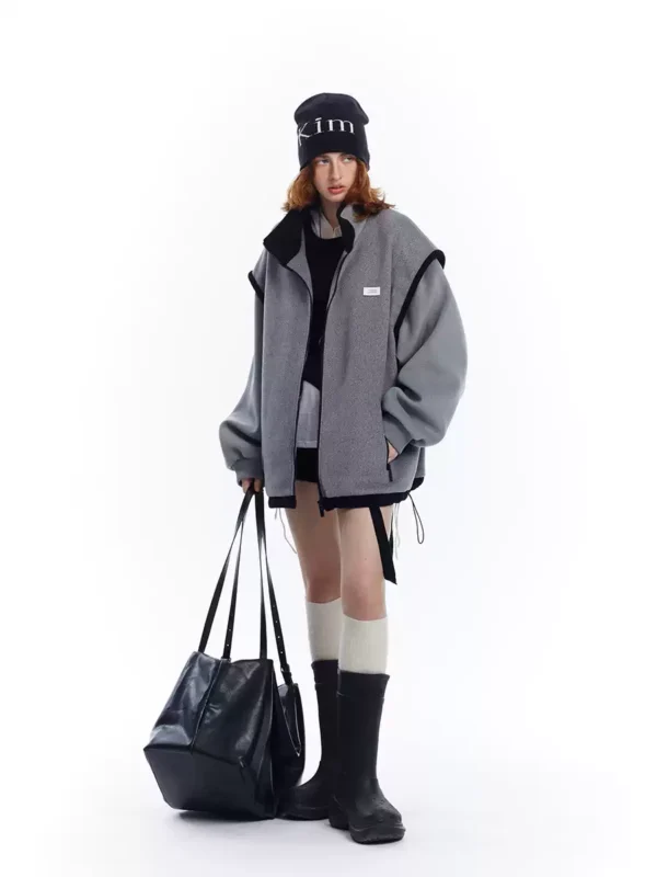 A woman in a grey patchwork woolen coat