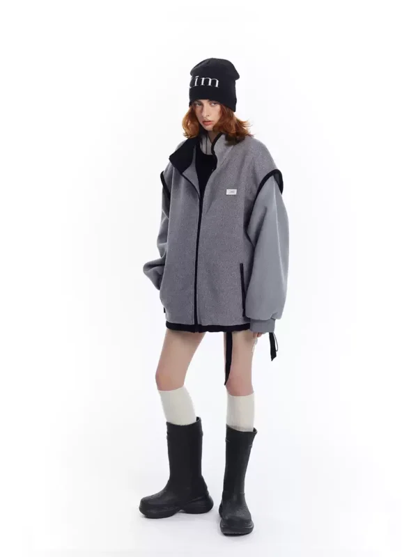 A woman in a grey patchwork woolen coat