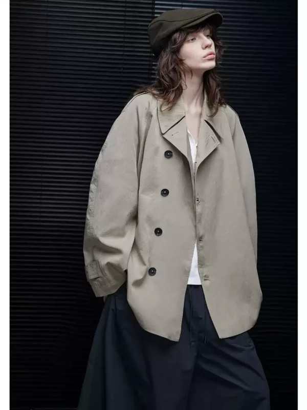 A woman wearing a light khaki windbreaker - Image 5