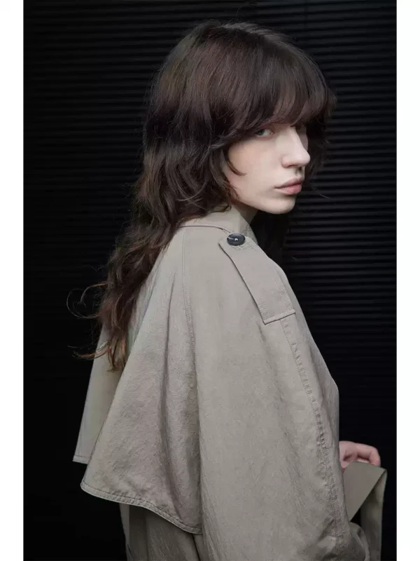 A woman wearing a light khaki windbreaker - Image 4