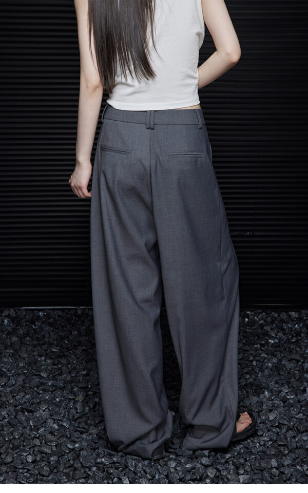A woman in loose and slimming grey trousers - Image 5