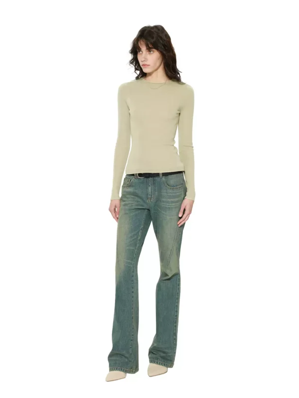 A woman in tight, slightly flared jeans