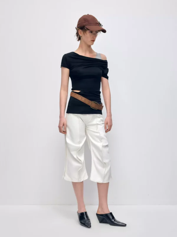 A woman in a T-shirt with a slanted shoulder and a swing neck