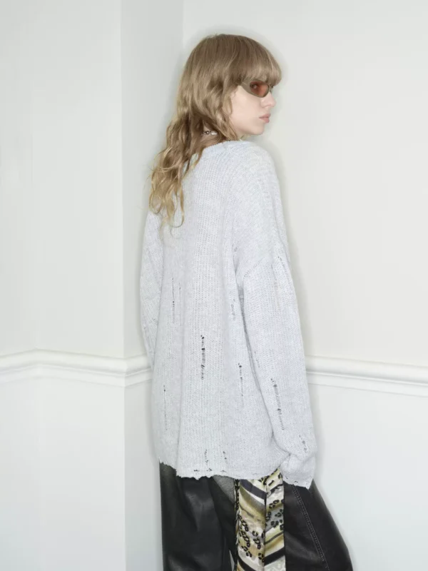 A woman in a laid-back grey heart-neck sweater - Image 3