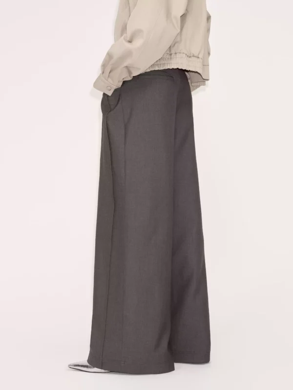 A woman in a grey suit pants with a sense of design - Image 4